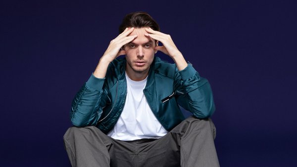 Co je spotřebitelský úvěr? Mladý muž sedí na podlaze a v obavách se drží za hlavu